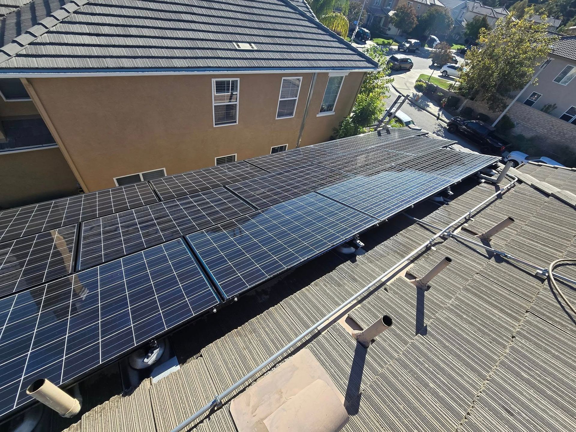 A row of solar panels on the roof of a house