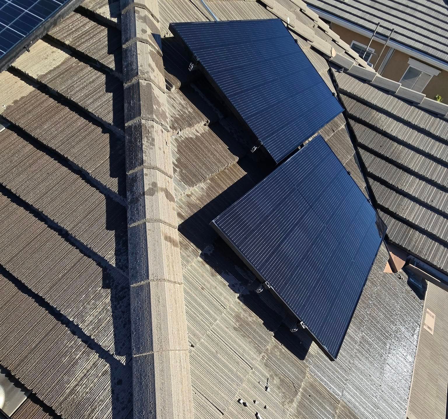 A roof with two solar panels on it