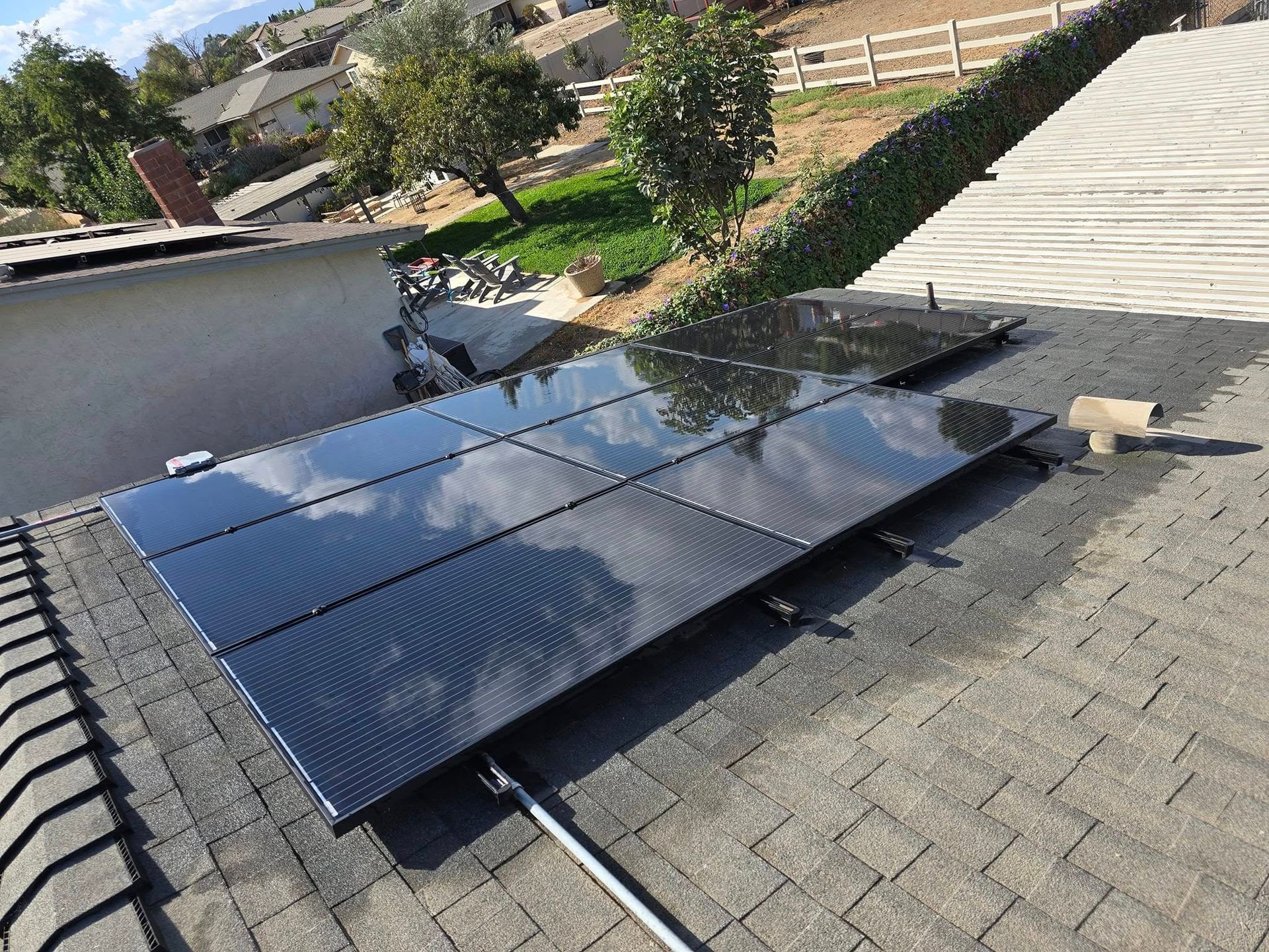 A row of solar panels are sitting on top of a roof.