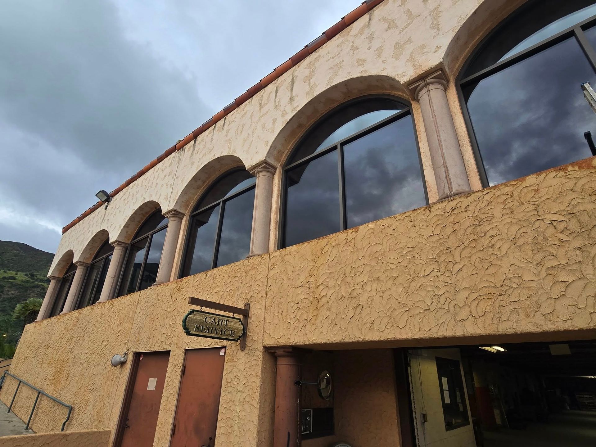 A large building with arched windows and a sign on the side