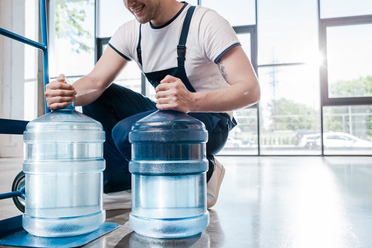 A Man Is Kneeling Down Next to Two Bottles of Water — Billabong Springs in Jimboomba, QLD