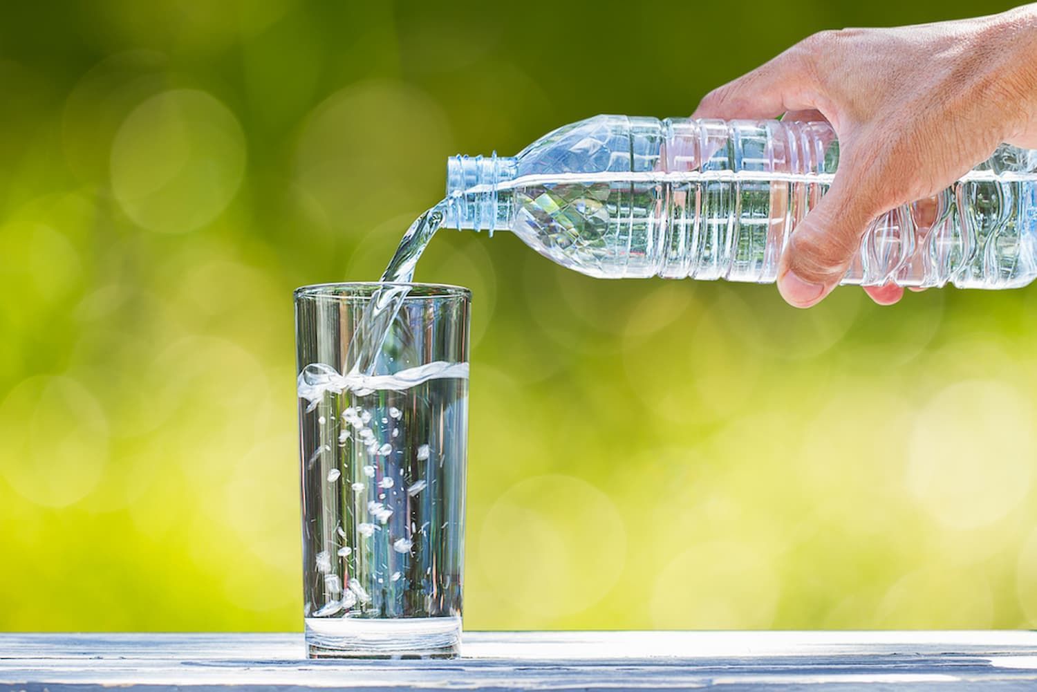 A Person Is Pouring Water from A Bottle Into a Glass — Billabong Springs in Jimboomba, QLD