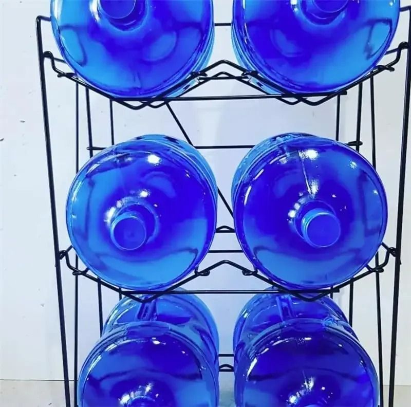 A Bunch Of Blue Water Bottles Stacked On Top Of Each Other — Billabong Springs in Jimboomba, QLD