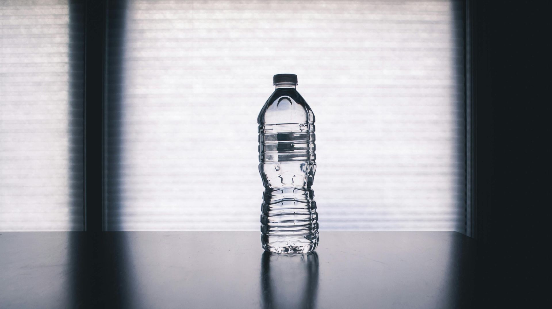 A Bottle Of Water Is Sitting On A Table In Front Of A Window — Billabong Springs in Sunshine Coast, QLD