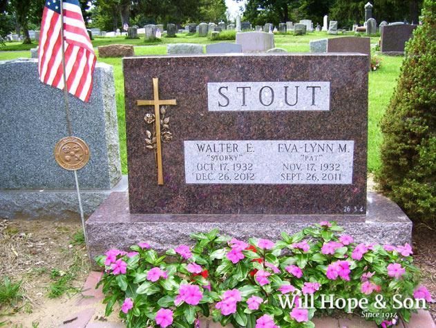 A polished granite cemetery monument engraved with 