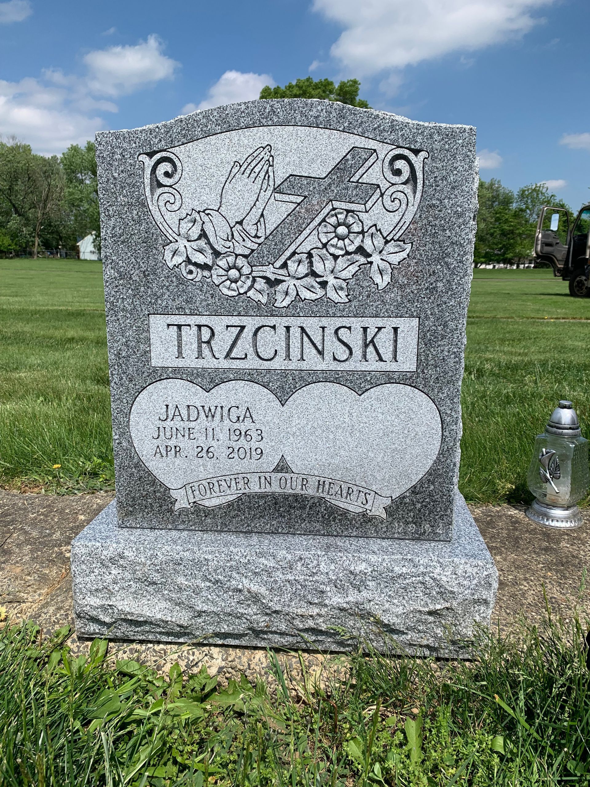 A grey granite tombstone with 