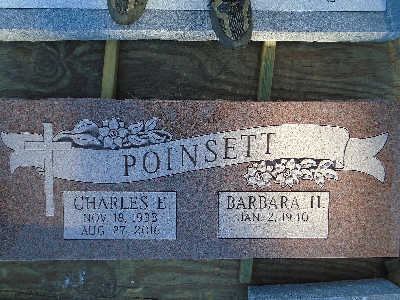 A granite grave marker for the Poinsett family, engraved with names and dates for Charles E. and Barbara H. Poinsett.