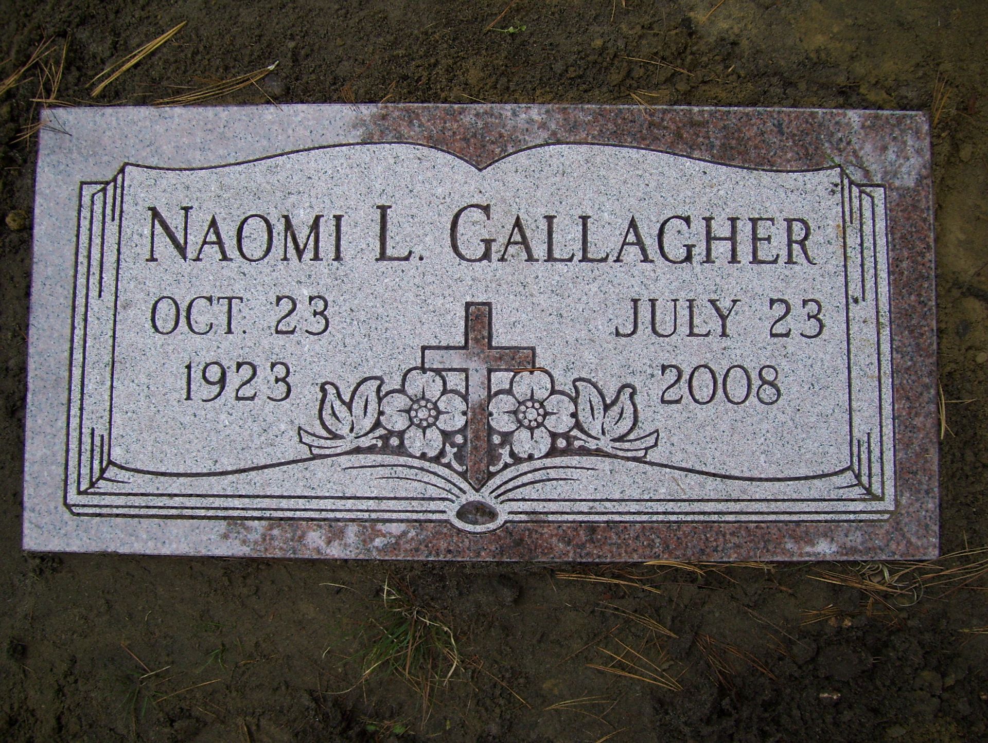 Granite grave marker for Naomi L. Gallagher (1923–2008) featuring an engraved open book and cross in the center.