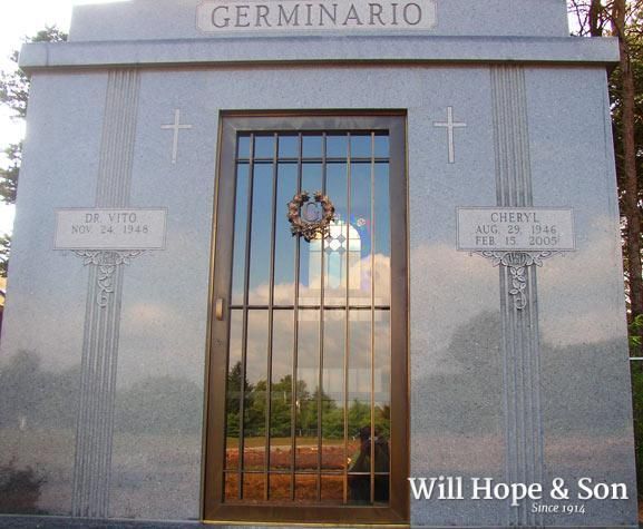 A grey granite mausoleum engraved with 