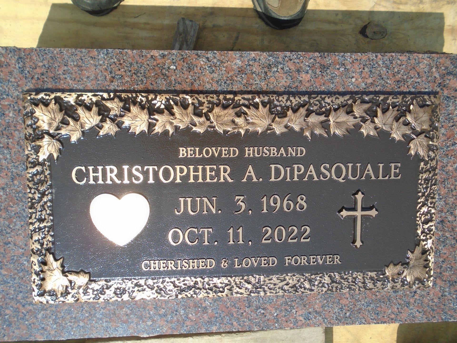 Bronze and granite grave marker for Christopher A. DiPasquale, born June 3, 1968, and died October 11, 2022.
