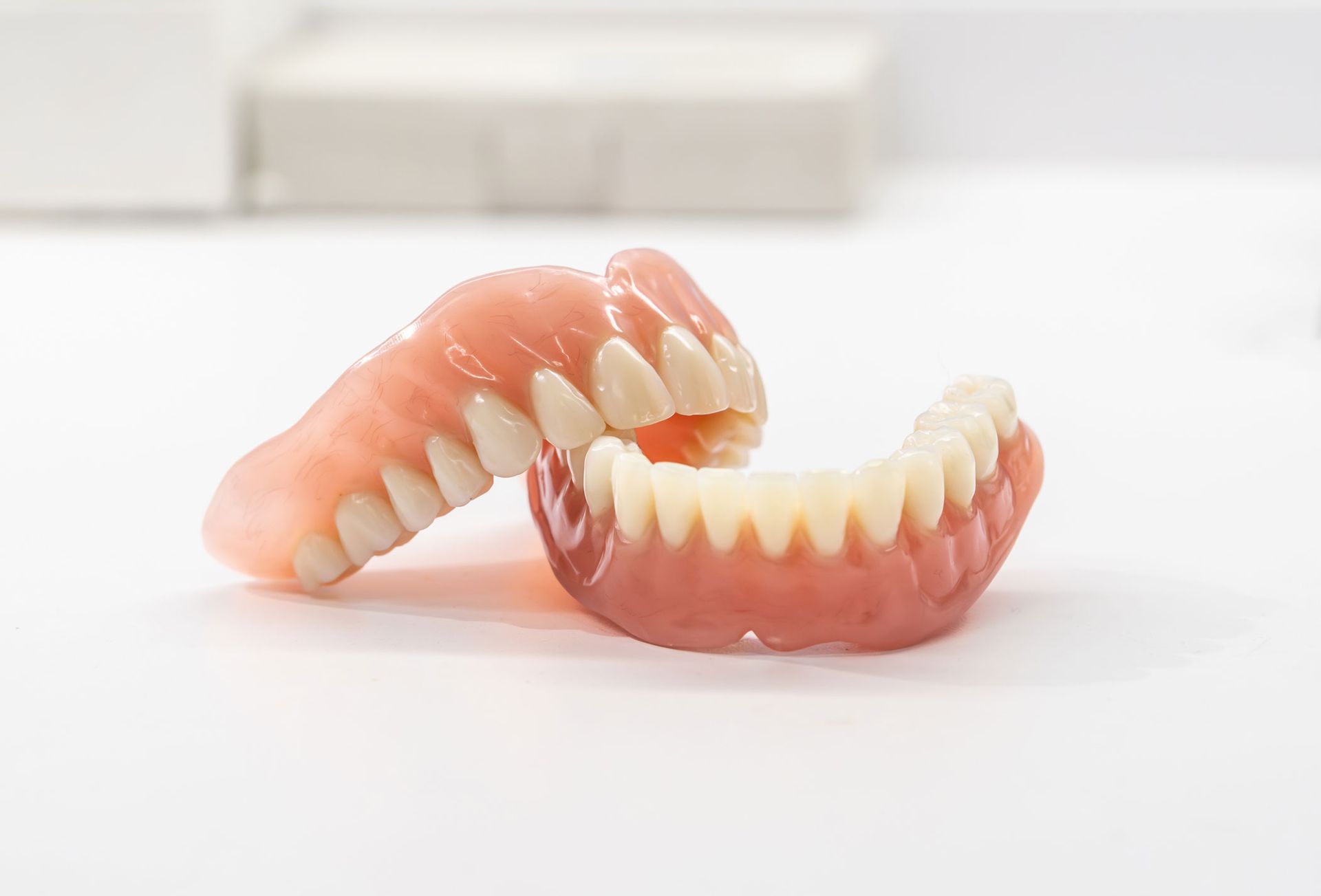 Close-up of a dental prosthetic model with artificial teeth and gums.