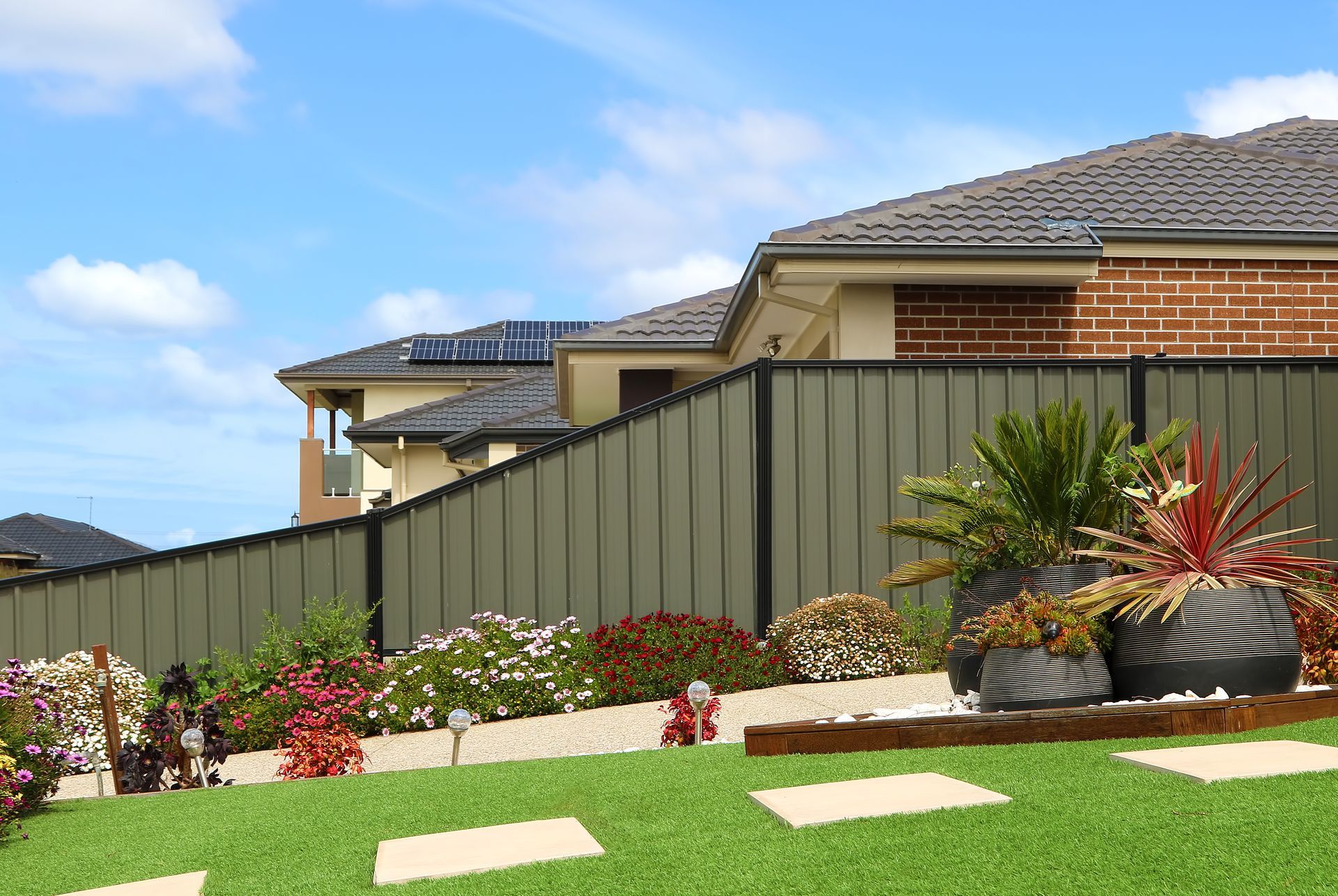 Brown wooden fence with concrete posts and base.