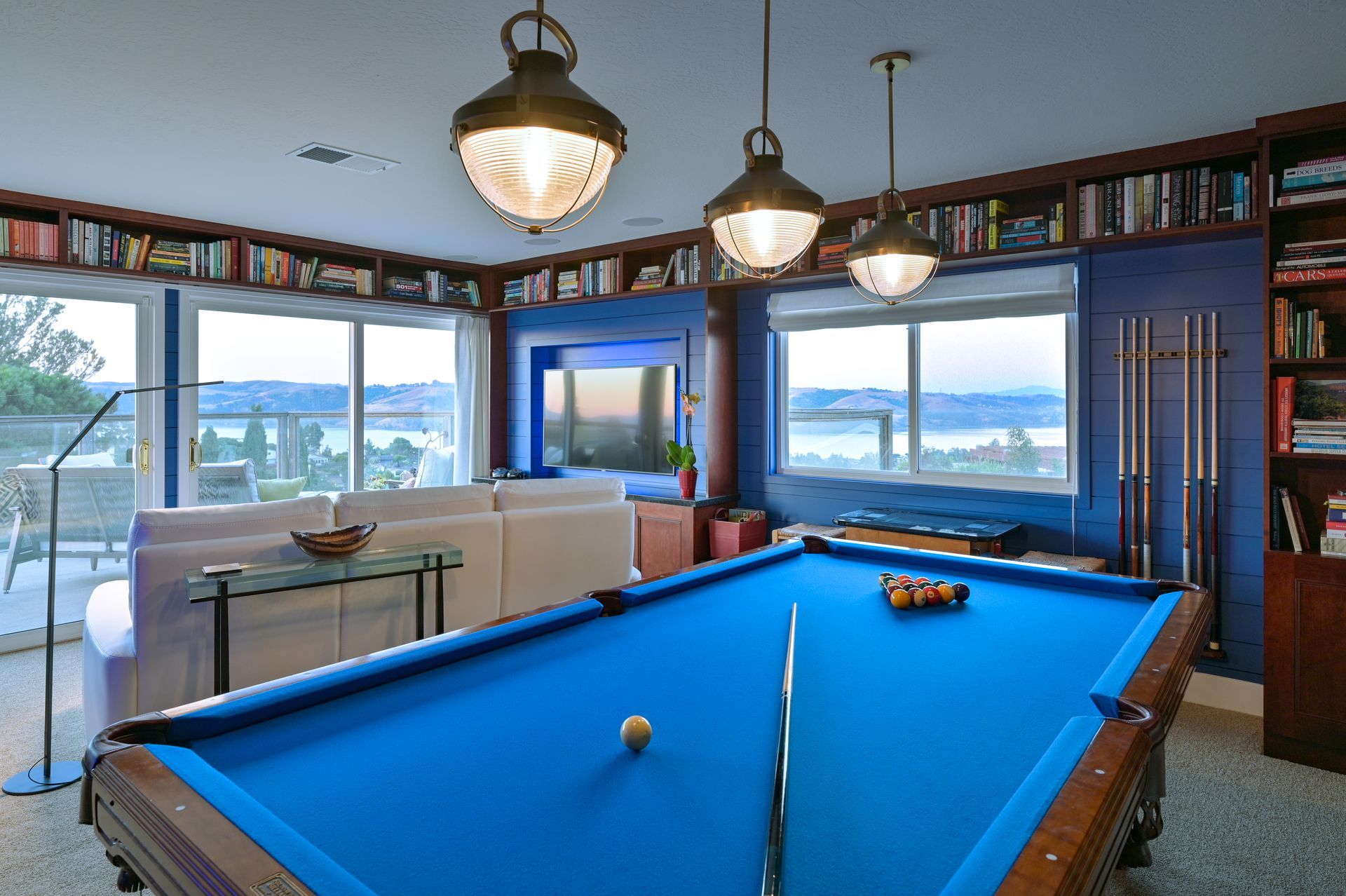 a pool table is in the middle of a living room
