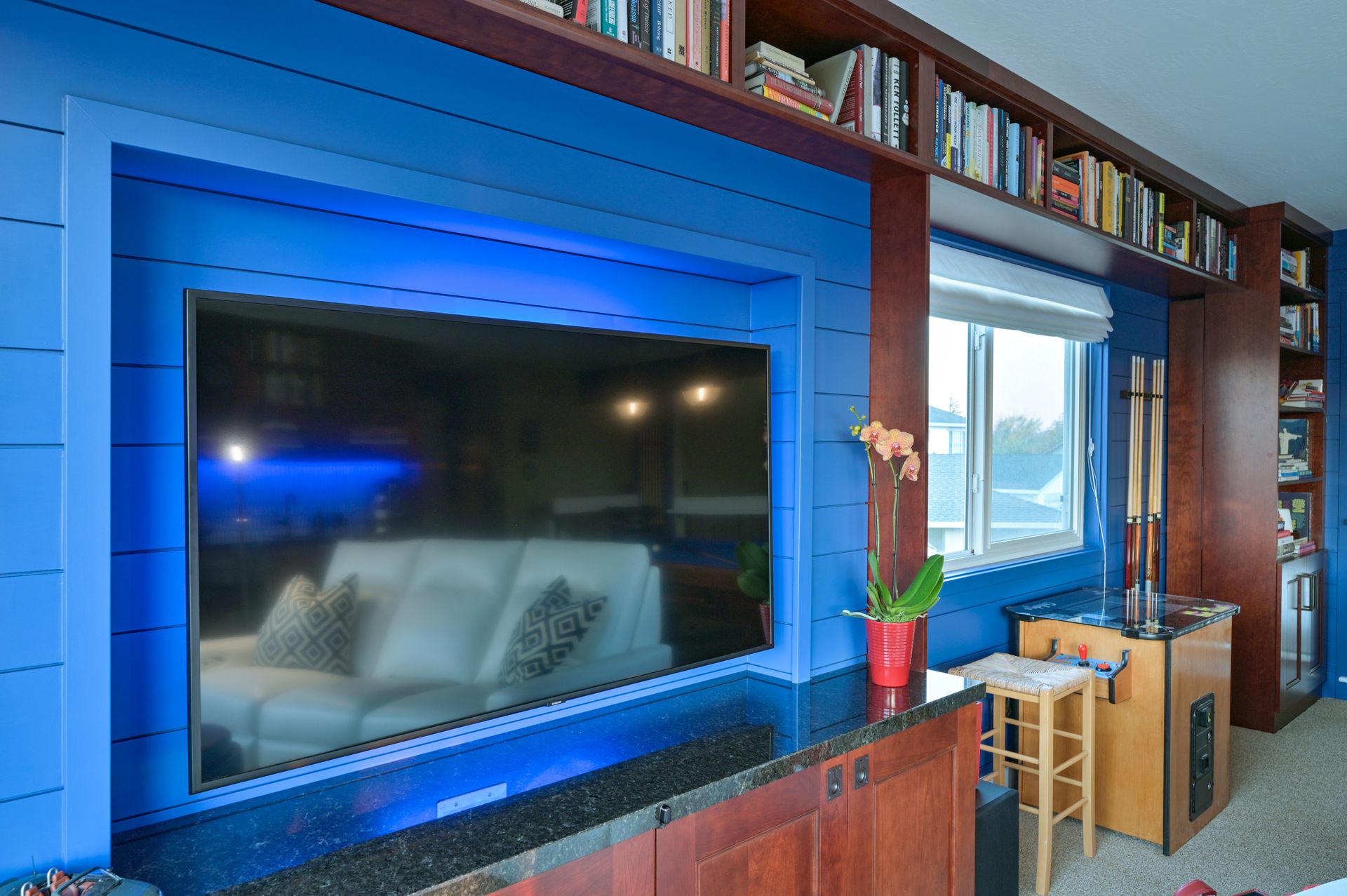a living room with blue walls and a flat screen tv