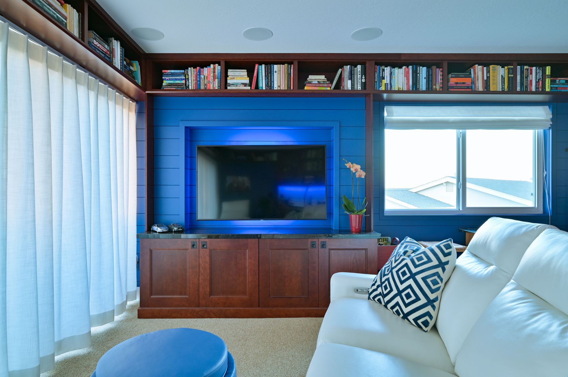 a living room with a white couch and a flat screen tv