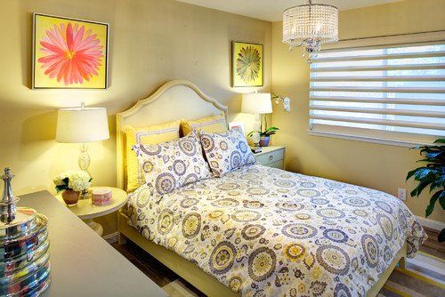 A bedroom with a bed , nightstand , lamps and a window.