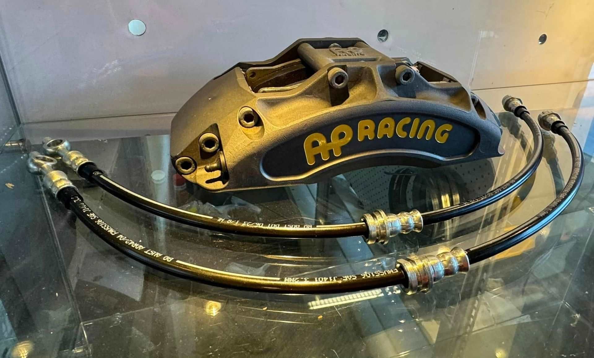 A Close Up of a Brake Caliper on a Glass Table — Aushose Canberra In Fyshwick, ACT