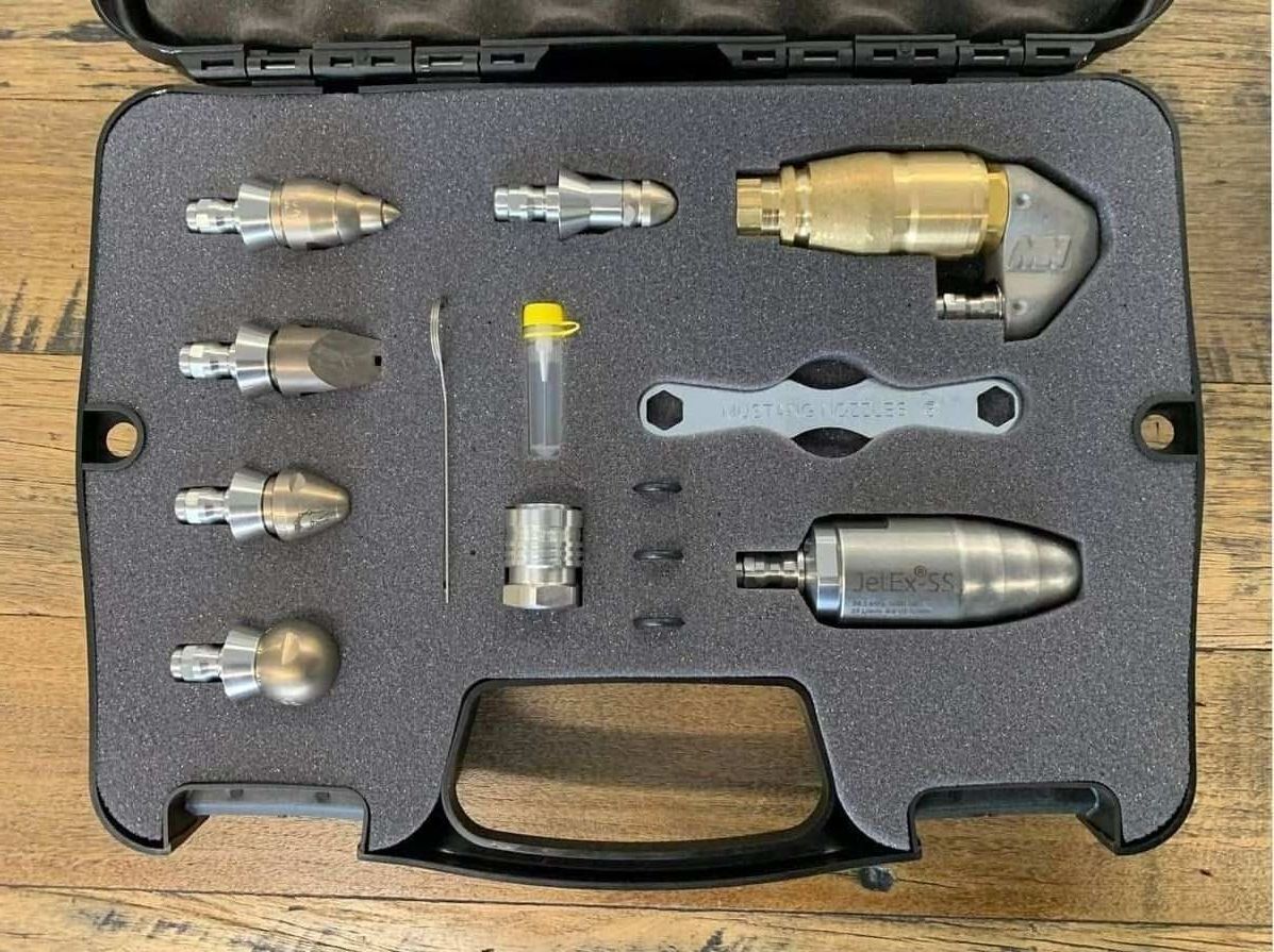 A Set of Drain Cleaning Tools in a Case on a Wooden Table — Aushose Canberra In Fyshwick, ACT