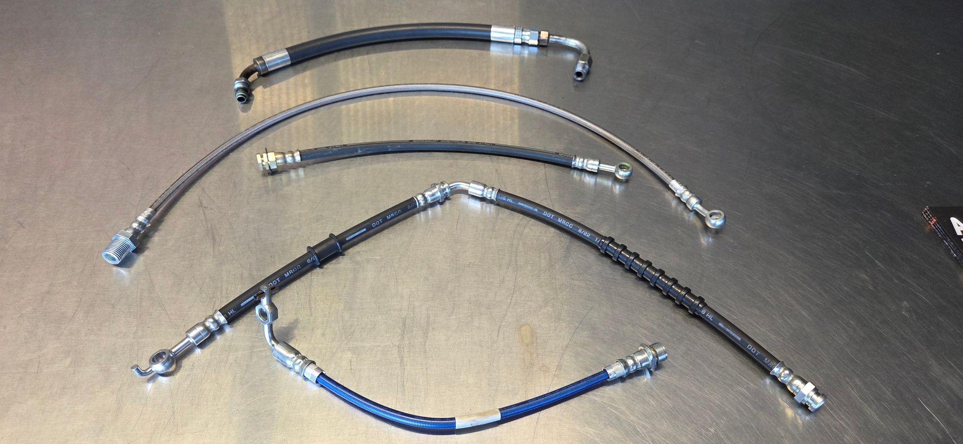 A group of hose sitting on top of a metal surface.