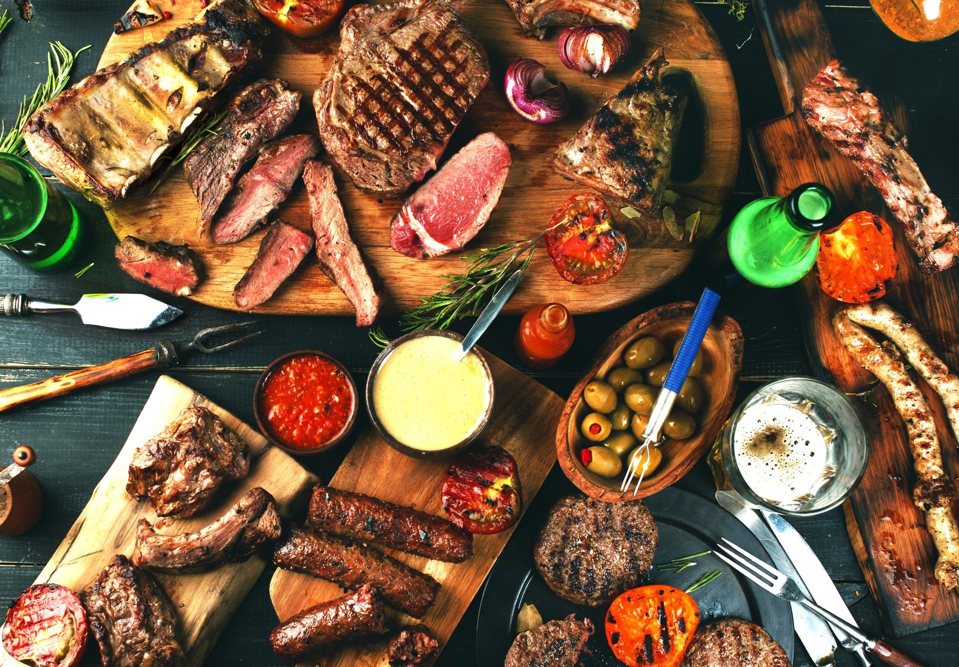A table topped with a variety of meats and vegetables.
