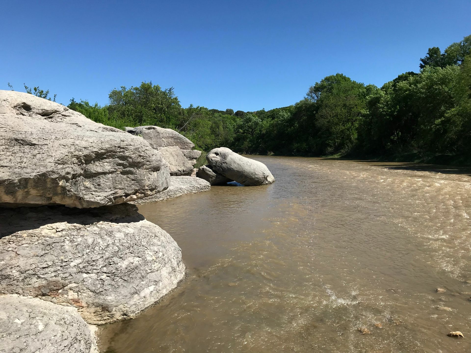 A river with a large rock in the middle of it