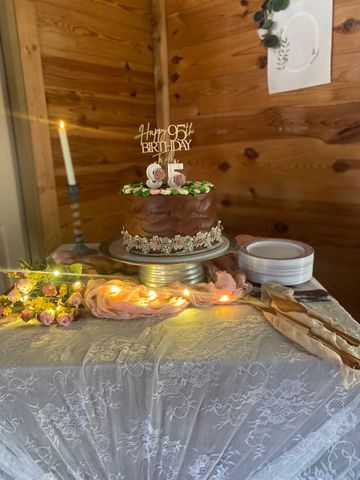 A cake is sitting on top of a table next to a candle.