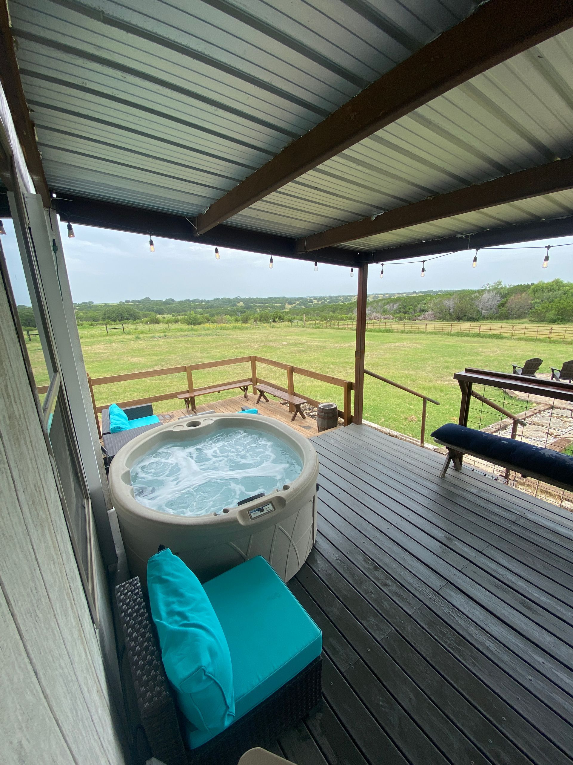 Two chairs are sitting next to a fire pit in front of a cabin.