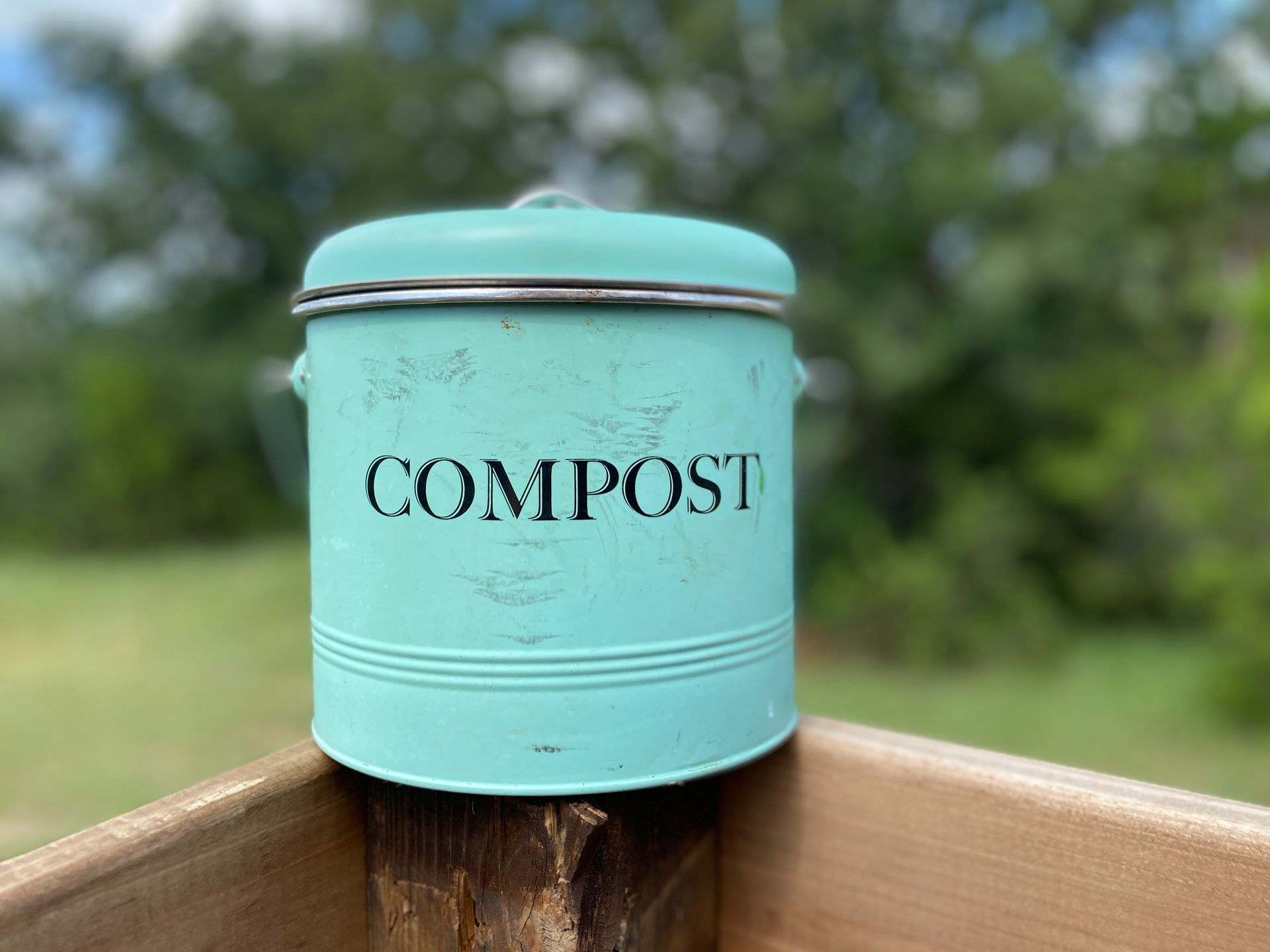 A bottle of wine sits on a table next to a hot tub