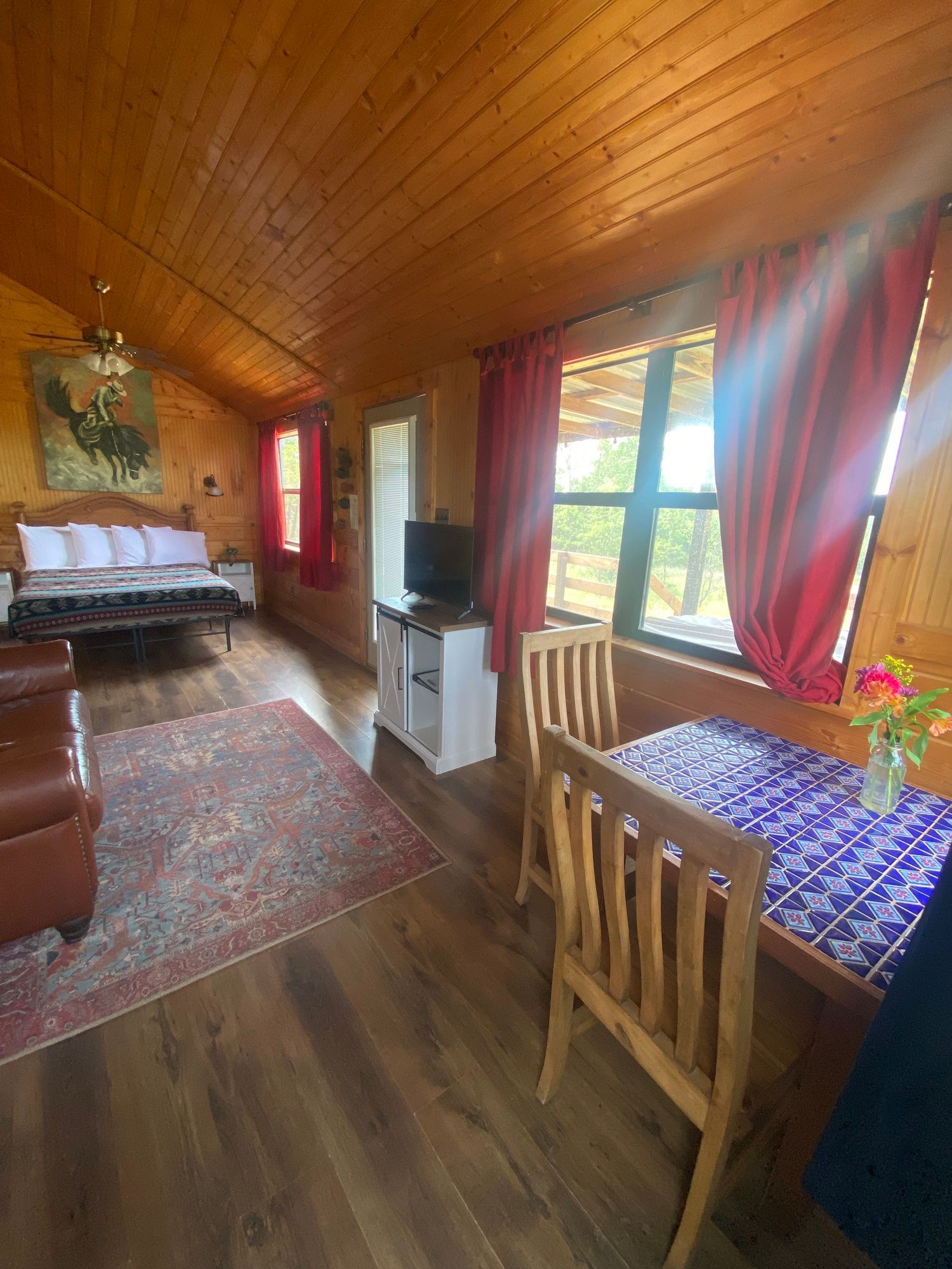 There is a table and chairs in the middle of the room.