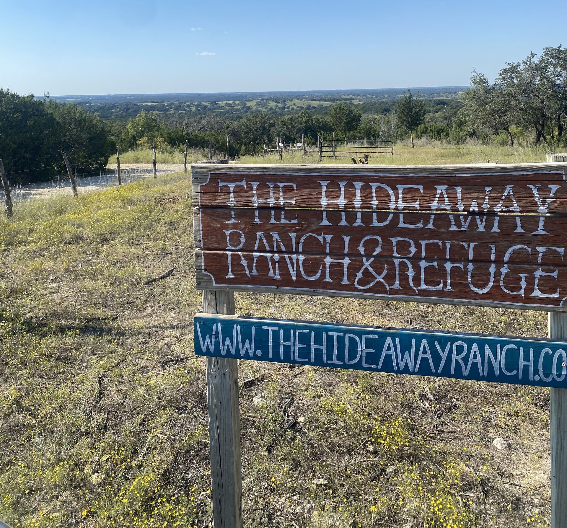 A wooden sign for the hideaway ranch and refuge