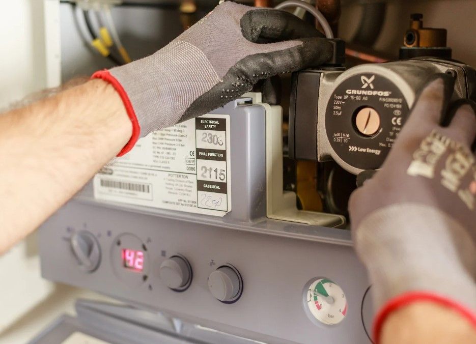 Derbyshire Plumbing & Heating Specialists carrying out and annual boiler  service of a combi boiler in Derby
