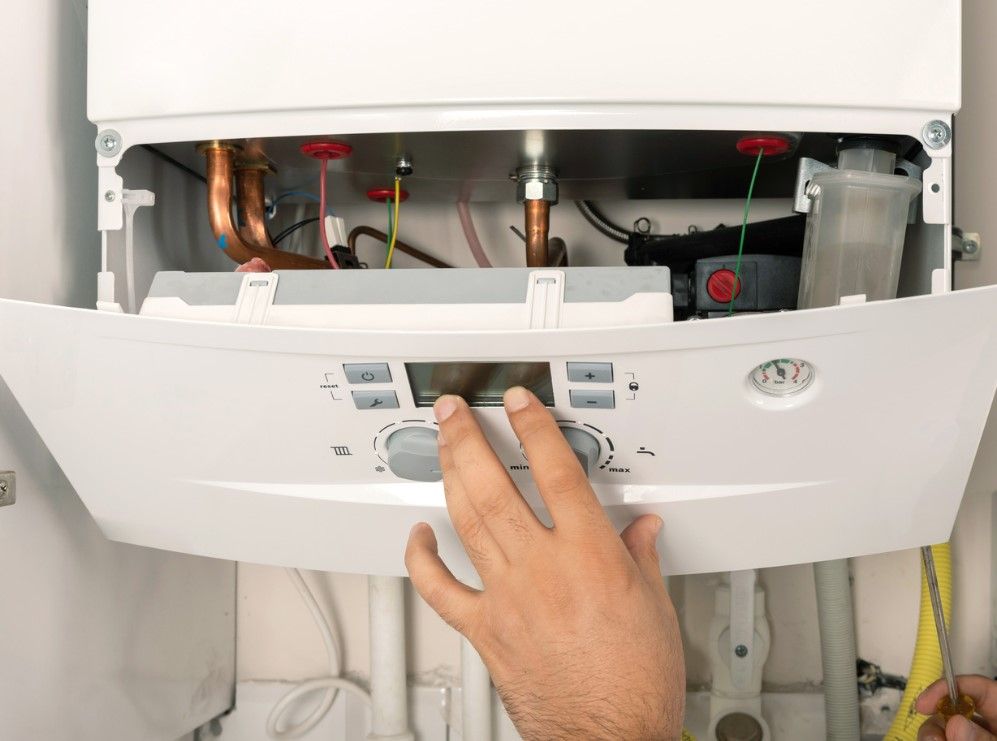 Derbyshire Plumbing & Heating Specialists fitting a new boiler in Ilkeston