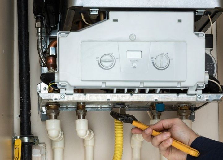 Derbyshire Plumbing & Heating Specialists repairing a boiler in Derby