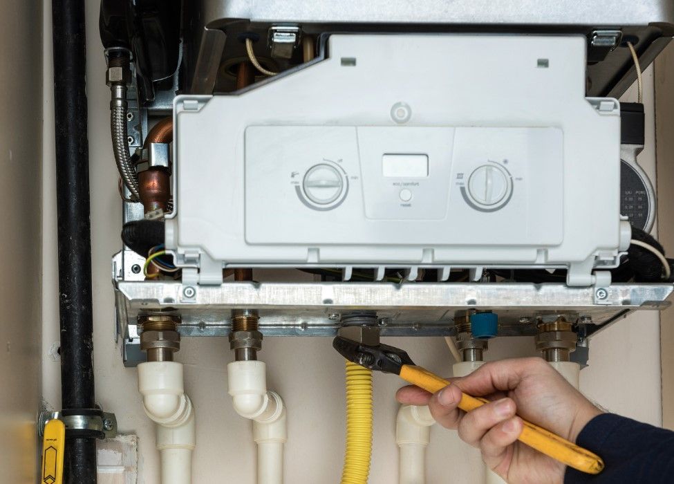 Derbyshire Plumbing & Heating Specialists repairing a boiler in Ilkeston