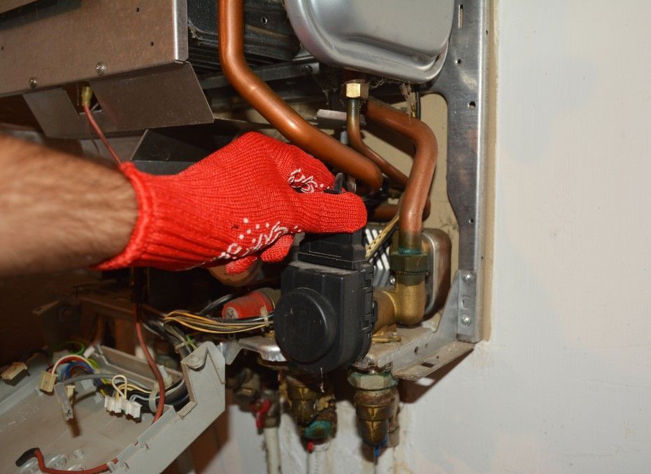Derbyshire Plumbing & Heating Specialists checking a water tank as part of a regular boiler service in Derby