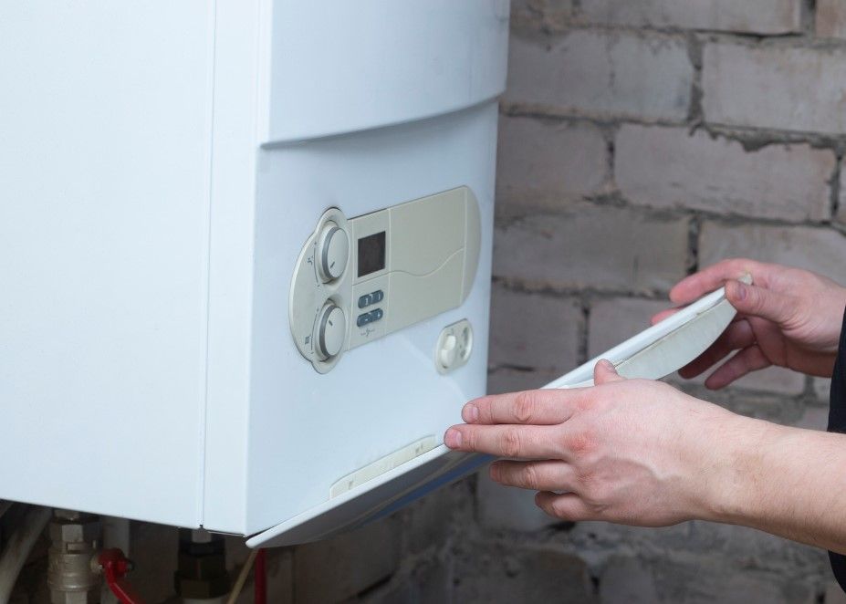 Derbyshire Plumbing & Heating Specialists replacing the cover following a boiler service in Derby