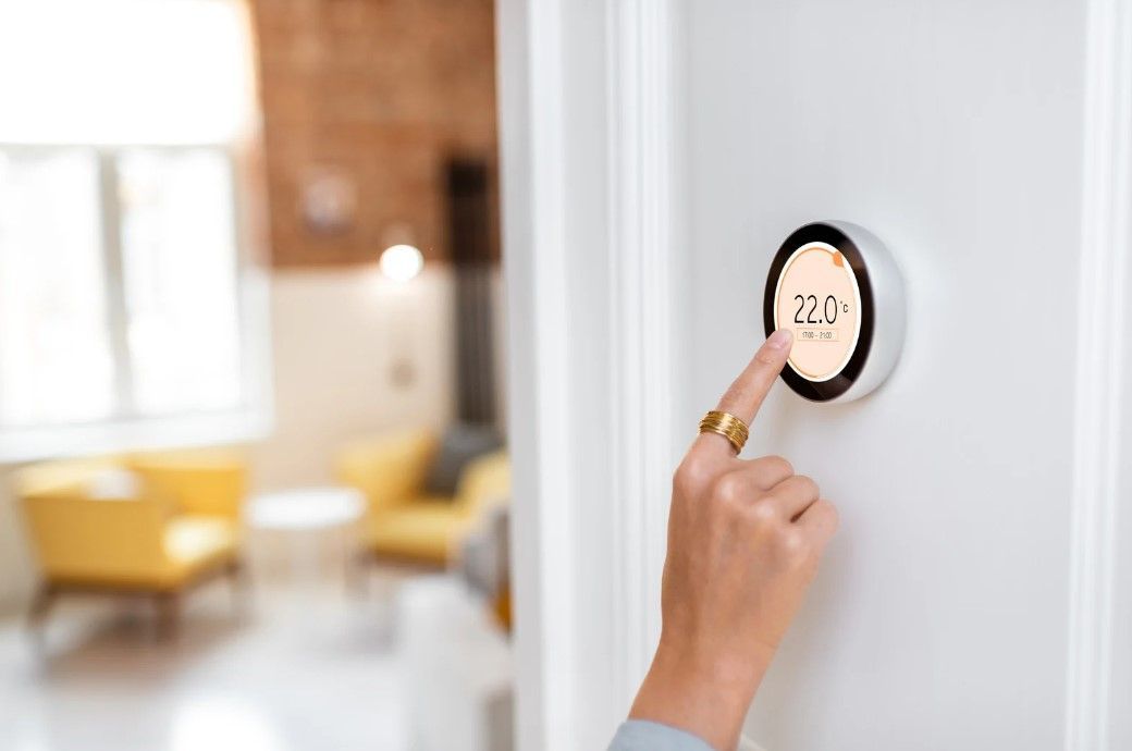 An Ilkeston customer adjusting Hive smart heating controller