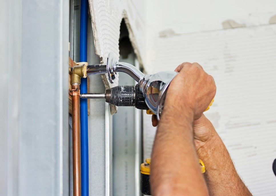 Derbyshire Plumbing & Heating Specialists installing a new shower in a bathroom in Derby