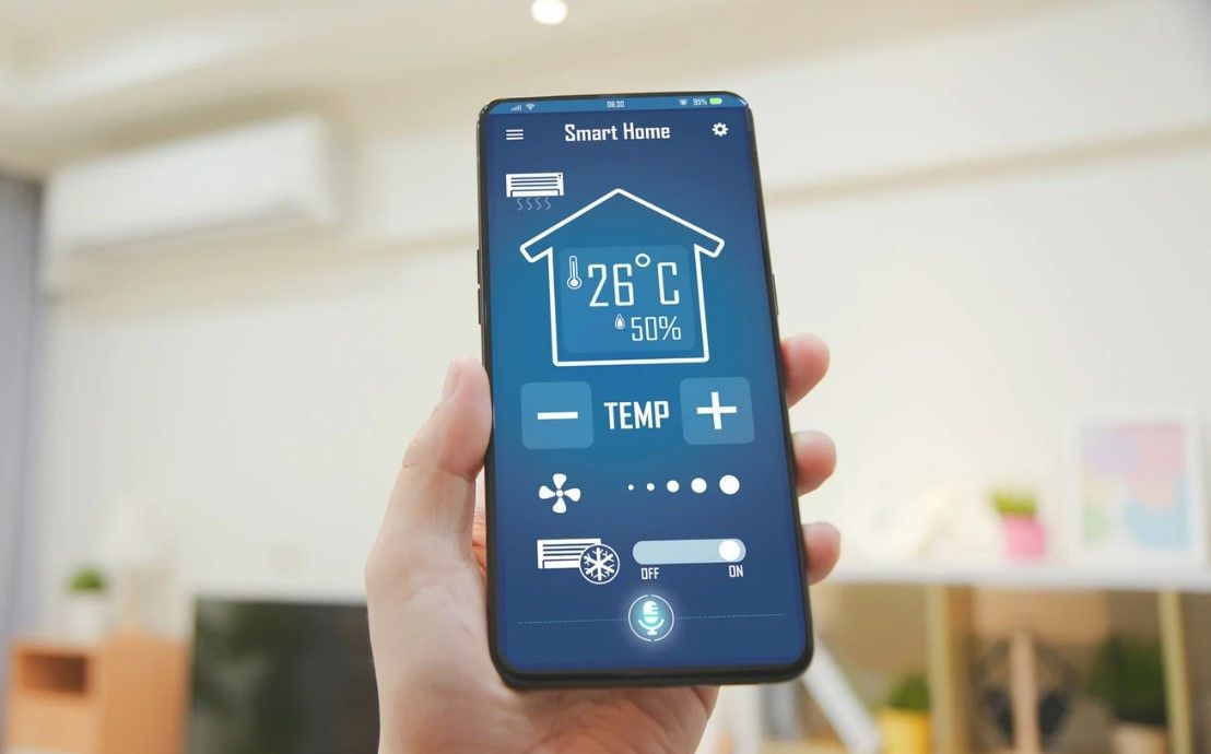 Derbyshire Plumbing & Heating Specialists checking a new smart heating controller app with a customer in Ashbourne