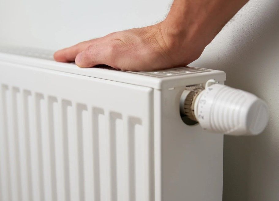 Derbyshire Plumbing & Heating Specialists testing a radiator after power flushing in Derby