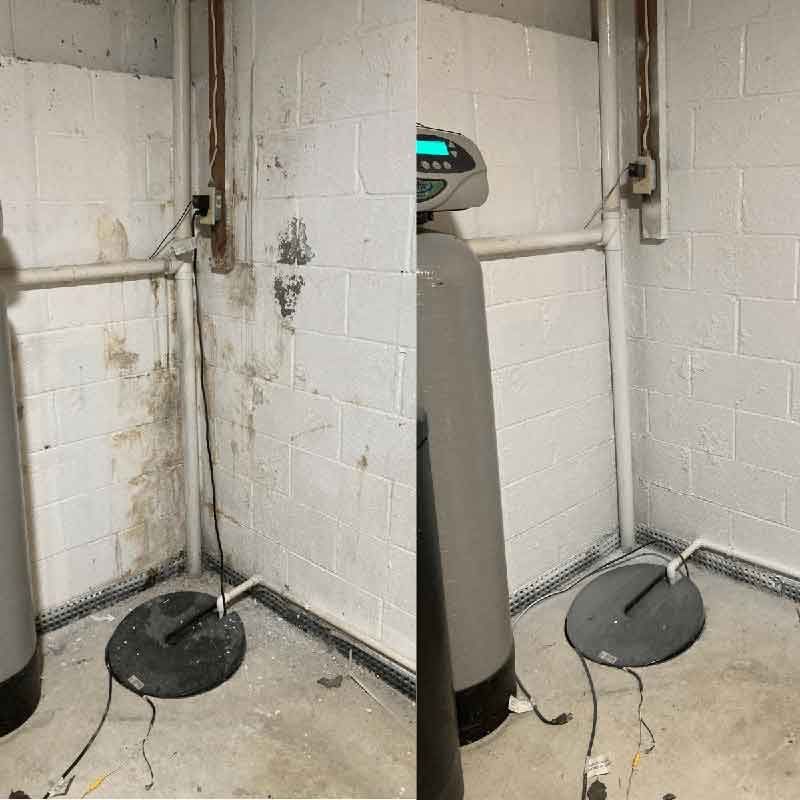 Before-and-after of a basement wall cleaned of mold and mildew, painted white.