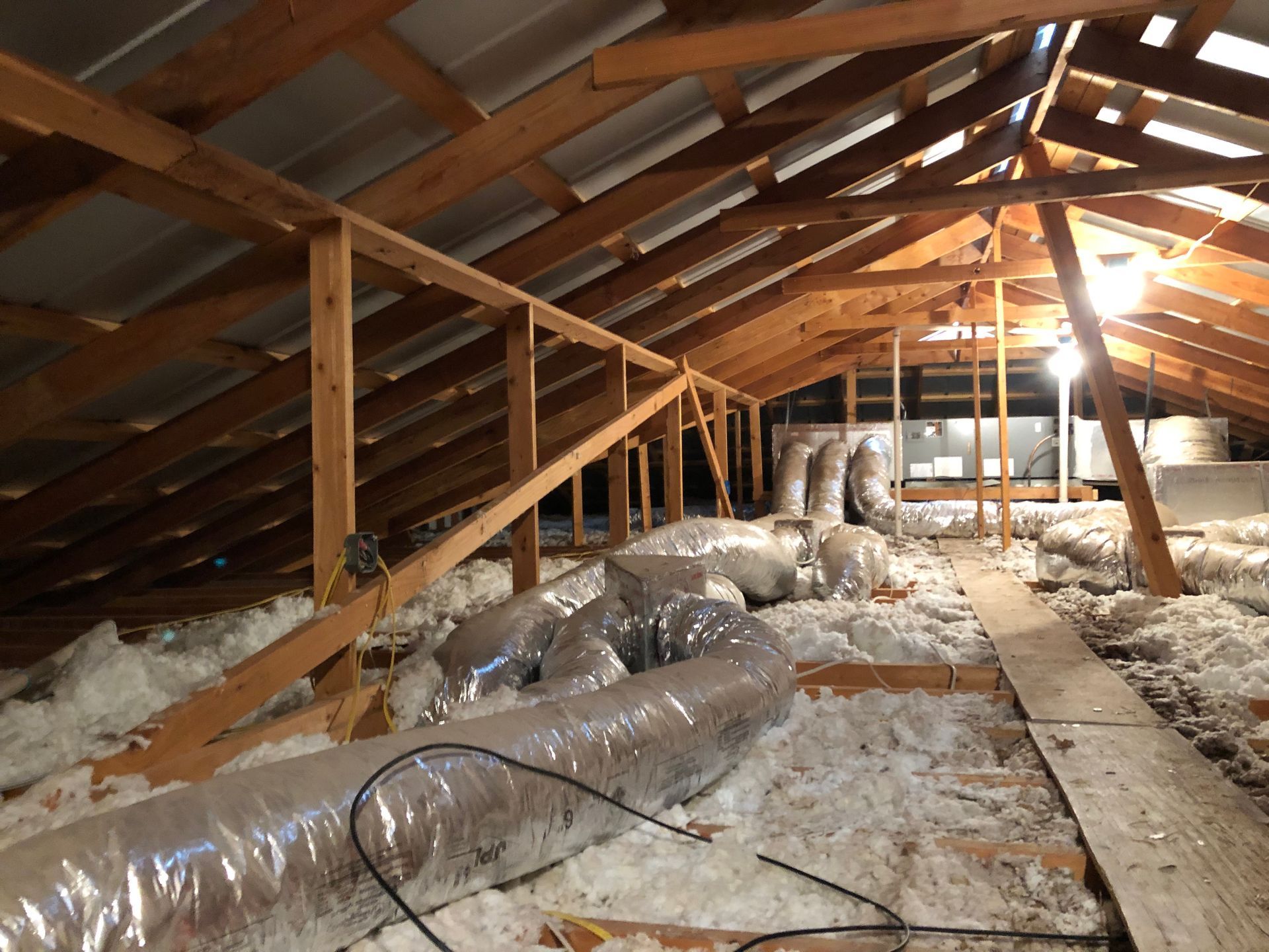 There is a lot of insulation in the attic of a house.