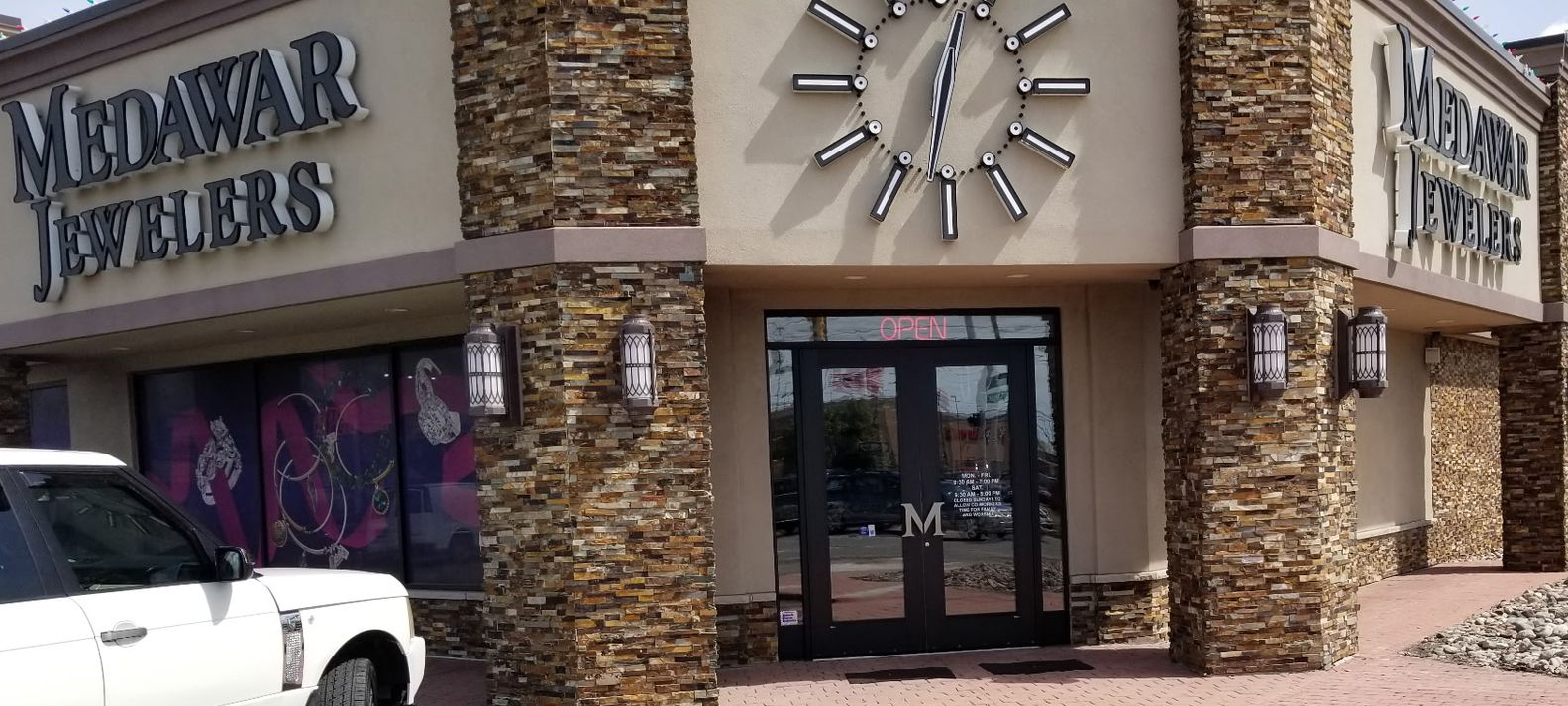 Medawar Jewelers storefront with a large clock logo above the entrance.