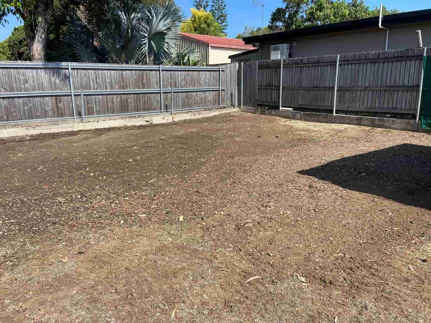 A Backyard With a Fence and a Lot of Dirt — RCJJ Mini Loaders In Mareeba, QLD