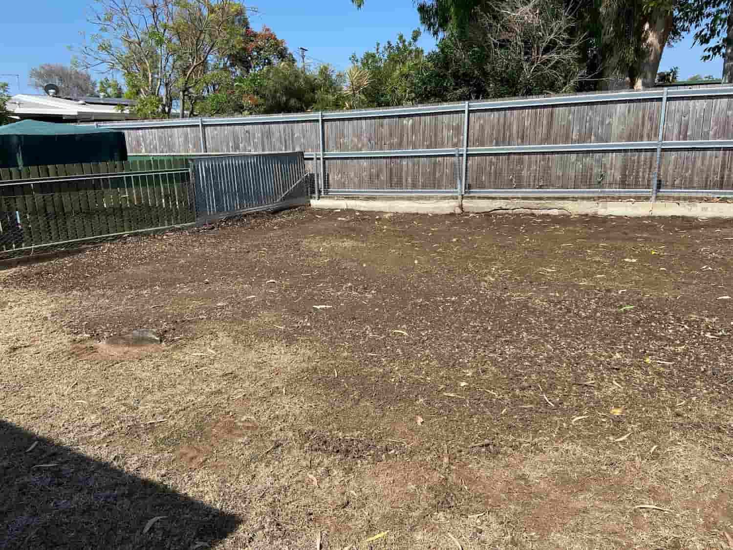 A Backyard With a Fence and a Lot of Grass — RCJJ Mini Loaders In Mareeba, QLD