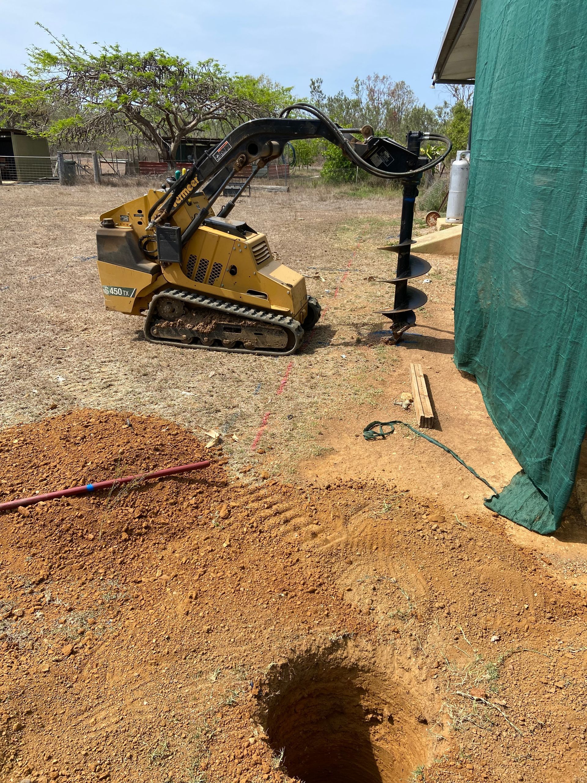 Mini Excavator Drilling Soil — RCJJ Mini Loaders In Mareeba, QLD