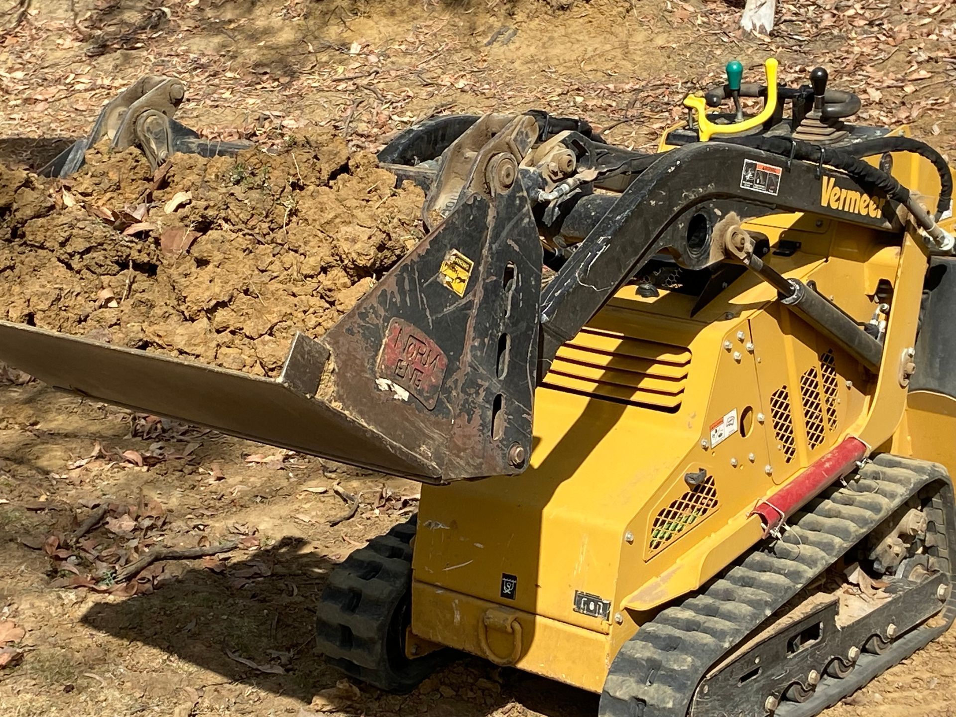 A Small Bulldozer is Sitting on Top of a Dirt Field — RCJJ Mini Loaders In Cairns, QLD