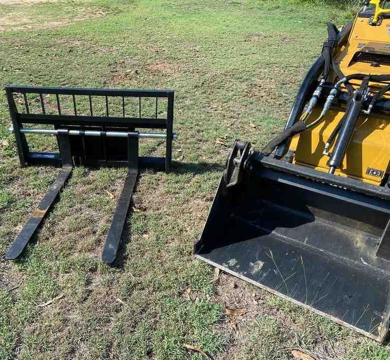 A Small Yellow Machine is Digging a Hole in the Ground — RCJJ Mini Loaders In Tablelands, QLD