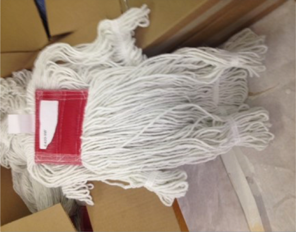 A white mop with a red label on it