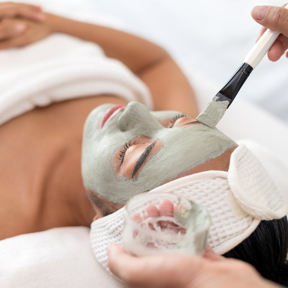 Applying Face Mask To A Woman — Great Neck, NY — Butterfly Garden Spa
